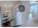 Hallway with dark wood stairs, carpet, chandelier, and a view into the bedroom at 16203 E Ridgeline Dr, Fountain Hills, AZ 85268