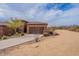 Exterior of the home with a 2-car garage, desert landscaping and a long driveway at 16203 E Ridgeline Dr, Fountain Hills, AZ 85268