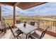 Covered patio with a four-chair dining table and expansive views of the surrounding desert landscape and a golf course at 16203 E Ridgeline Dr, Fountain Hills, AZ 85268