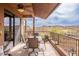 Scenic covered patio features a dining table, chairs, and beautiful desert landscape at 16203 E Ridgeline Dr, Fountain Hills, AZ 85268