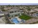 Aerial view of a backyard featuring a pool, lawn, privacy fence and covered patio area at 16606 S 15Th Ln, Phoenix, AZ 85045