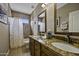 Bathroom with double vanity, granite countertop, and tiled shower at 16606 S 15Th Ln, Phoenix, AZ 85045