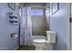 Cozy bathroom with blue walls, a shower-tub combo, and decorative shower curtain at 16606 S 15Th Ln, Phoenix, AZ 85045