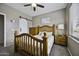 Comfortable bedroom featuring a ceiling fan, light gray paint, and a barn door at 16606 S 15Th Ln, Phoenix, AZ 85045