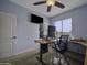 Bedroom featuring a multi-monitor desk setup and natural light at 16606 S 15Th Ln, Phoenix, AZ 85045