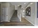 Hallway with staircase and wall accents, leading to other rooms in the home at 16606 S 15Th Ln, Phoenix, AZ 85045