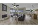 Open-concept living room with a fireplace, wood floors, and seamless flow into the kitchen at 16606 S 15Th Ln, Phoenix, AZ 85045