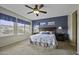 Comfortable main bedroom featuring a plush bed, blue accents, and large sunny window at 16606 S 15Th Ln, Phoenix, AZ 85045