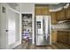 Walk-in pantry with shelves and storage beside the stainless steel refrigerator at 16606 S 15Th Ln, Phoenix, AZ 85045