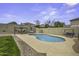 Inviting backyard with a sparkling pool, a covered seating area, and green grass at 16606 S 15Th Ln, Phoenix, AZ 85045