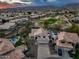 Stunning aerial view of a desert home with a pool and golf course in the backyard with mountain views at 16646 S 16Th St, Phoenix, AZ 85048