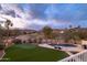 Panoramic aerial view of a stunning backyard with a pool, putting green, and manicured landscaping against a scenic backdrop at 16646 S 16Th St, Phoenix, AZ 85048