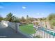 Elevated view of the serene backyard with a putting green, pool, mature trees, and privacy at 16646 S 16Th St, Phoenix, AZ 85048