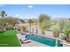 Aerial view of the resort-style backyard featuring a pool, putting green, and desert landscape at 16646 S 16Th St, Phoenix, AZ 85048