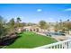 Expansive backyard showcasing a pool, putting green, desert landscaping, and mountain views at 16646 S 16Th St, Phoenix, AZ 85048