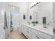 Well-lit bathroom features double sinks with vanity, a shower and an open doorway at 16646 S 16Th St, Phoenix, AZ 85048