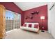 Bedroom with red walls, sliding glass doors, and neutral carpet at 16646 S 16Th St, Phoenix, AZ 85048