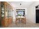 Dining room with large window, carpet flooring, and wooden hutch at 16646 S 16Th St, Phoenix, AZ 85048