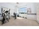 Carpeted exercise room with weight machines, free weights and large windows at 16646 S 16Th St, Phoenix, AZ 85048