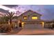 Charming two-story home featuring a three-car garage and terra cotta roof, set against a vibrant twilight sky at 16646 S 16Th St, Phoenix, AZ 85048