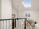 Bright foyer with a skylight, black and white banister, and a view of the living area at 16646 S 16Th St, Phoenix, AZ 85048