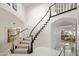 Elegant foyer with a curved staircase and tiled floors leading to the main living spaces at 16646 S 16Th St, Phoenix, AZ 85048