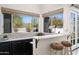 Kitchen bar featuring a bar top, sink, large windows, and stools at 16646 S 16Th St, Phoenix, AZ 85048