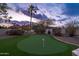 Well-maintained putting green with professional landscaping, offering a fun and functional space for golf practice at 16646 S 16Th St, Phoenix, AZ 85048