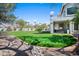 Expansive backyard showcasing a professionally designed putting green, providing endless fun for golf enthusiasts at 16646 S 16Th St, Phoenix, AZ 85048