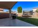 Covered patio with a built-in BBQ and trampoline in a well-maintained backyard at 17574 W Corrine Dr, Surprise, AZ 85388