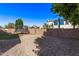 Spacious backyard featuring a trampoline and a well-maintained gravel landscape for outdoor enjoyment at 17574 W Corrine Dr, Surprise, AZ 85388