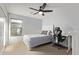 Bright bedroom featuring a ceiling fan, natural light, and desk area at 17574 W Corrine Dr, Surprise, AZ 85388