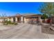 Inviting single-story home featuring well-maintained landscaping, a two-car garage, and a covered front porch at 17574 W Corrine Dr, Surprise, AZ 85388