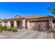 Charming single-story home with desert landscaping, a two-car garage, and covered front porch at 17574 W Corrine Dr, Surprise, AZ 85388