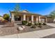 Inviting single-story home with desert landscaping, a covered entrance, and a convenient two-car garage at 17574 W Corrine Dr, Surprise, AZ 85388