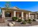 Attractive single-story house with desert landscaping, a covered front porch, and a two-car garage at 17574 W Corrine Dr, Surprise, AZ 85388