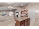 Kitchen with a center island, granite counters, and views of the adjacent living area at 17574 W Corrine Dr, Surprise, AZ 85388