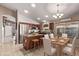 The kitchen has a center island, stainless steel refrigerator, and a table with seating for six, bathed in natural light at 17574 W Corrine Dr, Surprise, AZ 85388