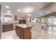 Open-concept kitchen showcasing a kitchen island and seamless flow to the living area at 17574 W Corrine Dr, Surprise, AZ 85388