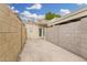 Enclosed backyard area with block fencing and access to the home, offering privacy and security at 1817 W Claremont St, Phoenix, AZ 85015