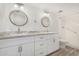 Bright bathroom with dual sinks, round mirrors, and modern fixtures at 1817 W Claremont St, Phoenix, AZ 85015