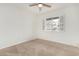 Bedroom featuring carpeted flooring, ceiling fan, and window with white blinds at 1817 W Claremont St, Phoenix, AZ 85015