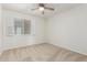 Bedroom featuring carpeted flooring, ceiling fan, and window with white blinds at 1817 W Claremont St, Phoenix, AZ 85015