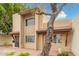 Inviting two-story home with security door, mature tree, and low-maintenance desert landscaping at 1817 W Claremont St, Phoenix, AZ 85015