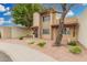 Beautiful two-story home exterior featuring well-kept yard with decorative rock and mature tree at 1817 W Claremont St, Phoenix, AZ 85015