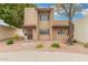 Two-story home featuring stucco siding, security door, mature trees and low-maintenance landscaping at 1817 W Claremont St, Phoenix, AZ 85015