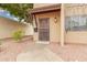 Close-up view of home's front entrance with iron security door, desert landscaping, and covered entry at 1817 W Claremont St, Phoenix, AZ 85015