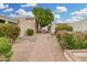 Landscaped walkway with lush greenery and flowering bushes, leading to the home's entrance at 1817 W Claremont St, Phoenix, AZ 85015