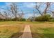 Expansive backyard showcasing mature trees, a play structure, and plenty of space for recreational activities and relaxation at 1824 W State Ave, Phoenix, AZ 85021