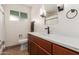 Bathroom with wood vanity, white countertop, modern fixtures, and a towel rack at 1824 W State Ave, Phoenix, AZ 85021